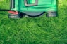 green and black lawnmower on green grass