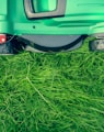 green and black lawnmower on green grass