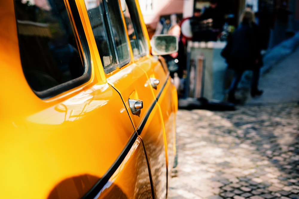 yellow car beside street