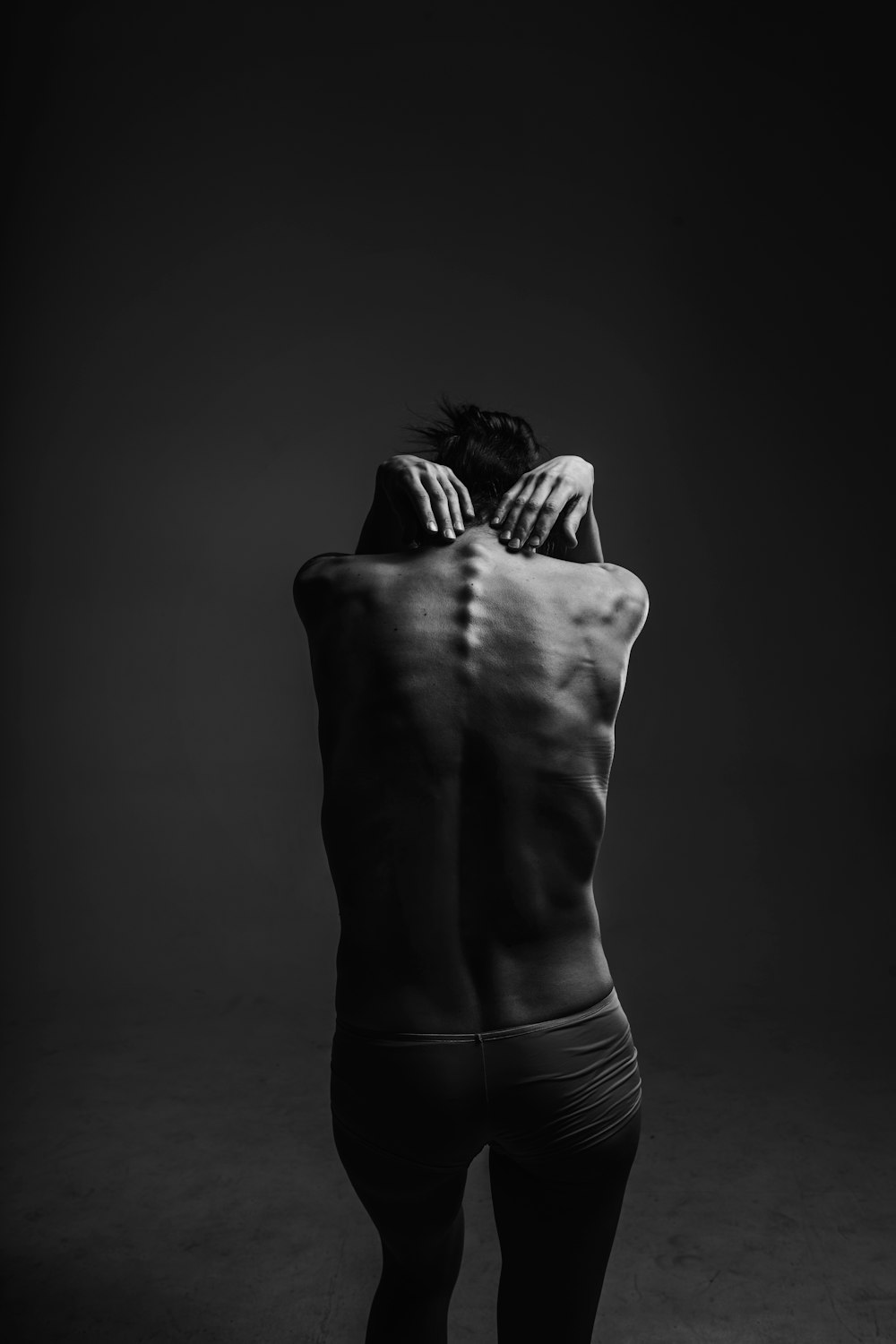 A black and white image of a person sticking their spine out in a photography studio in Kyiv city