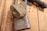 Two vintage Yale padlocks are attached to a wooden door. The locks are made of metal with a bronze hue, and the Yale logo is prominently displayed on each lock. The background consists of a textured wooden surface with warm tones.