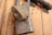 Two vintage Yale padlocks are attached to a wooden door. The locks are made of metal with a bronze hue, and the Yale logo is prominently displayed on each lock. The background consists of a textured wooden surface with warm tones.