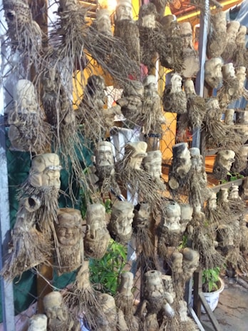 A mixed-media installation displaying traditional wood carving combined with repurposed fabric elements.