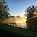 Guests enjoying a serene morning on the wooden dock by the lake.