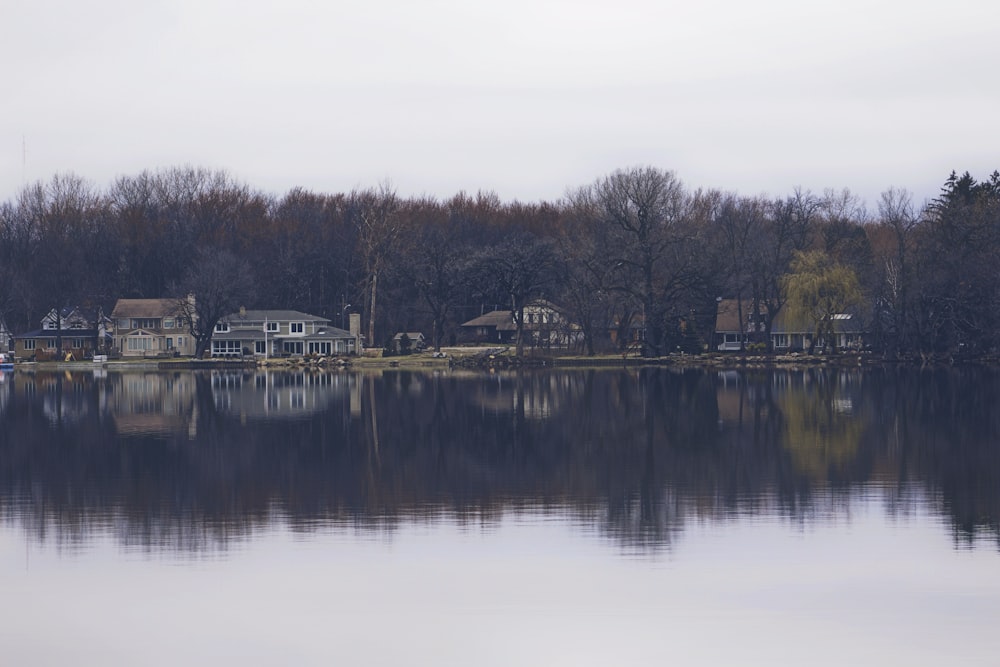 Cottages on the water in the middle of the woods, perfectly reflecting off the lake.