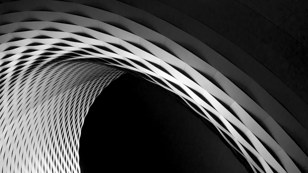 A curve in a latticework facade in black and white
