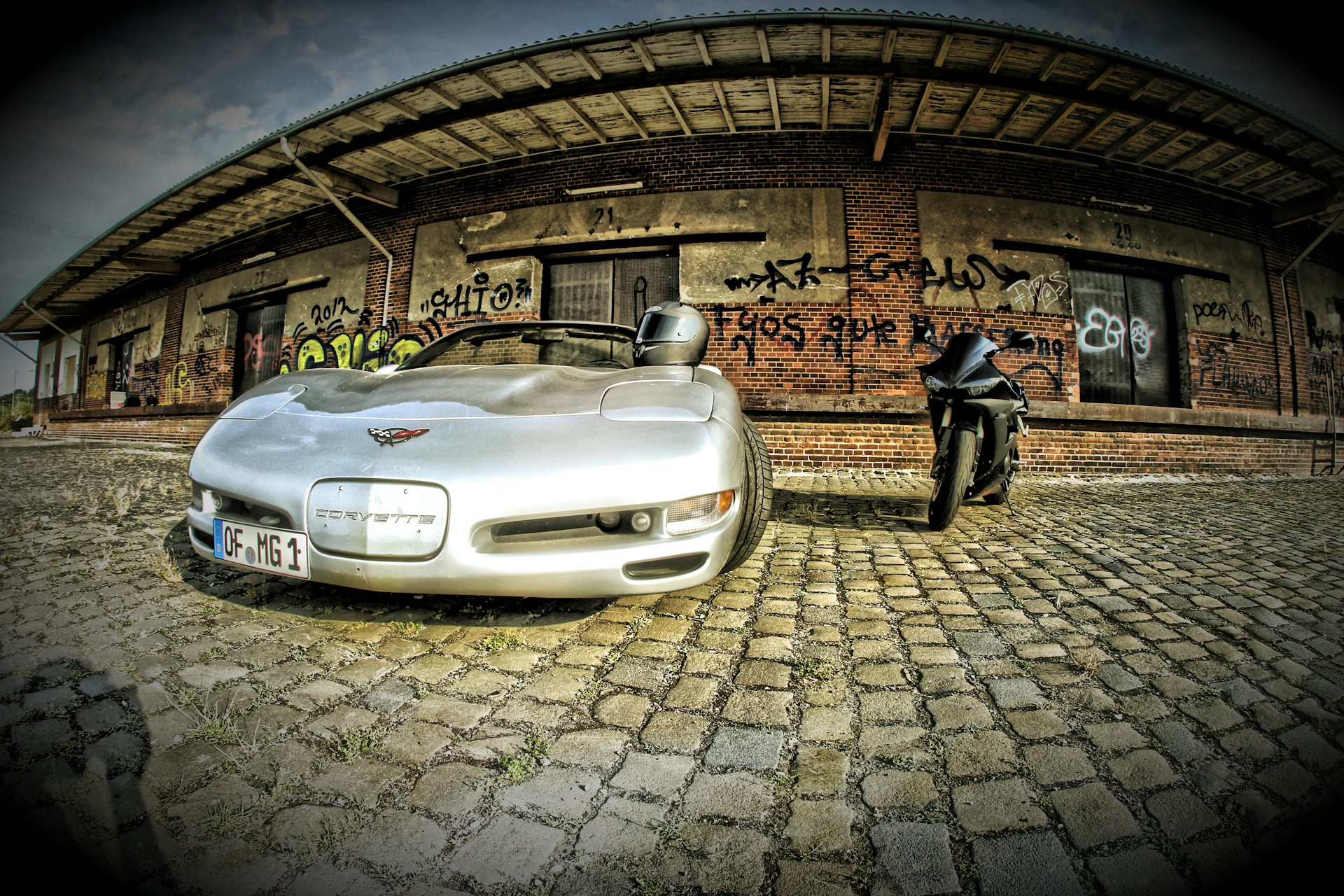 A dynamic shot of a sleek car and a motorcycle parked side by side, symbolizing the auto and moto insurance services offered.