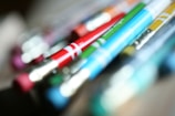 Close-up of vibrant school supplies including pens, markers, and erasers.