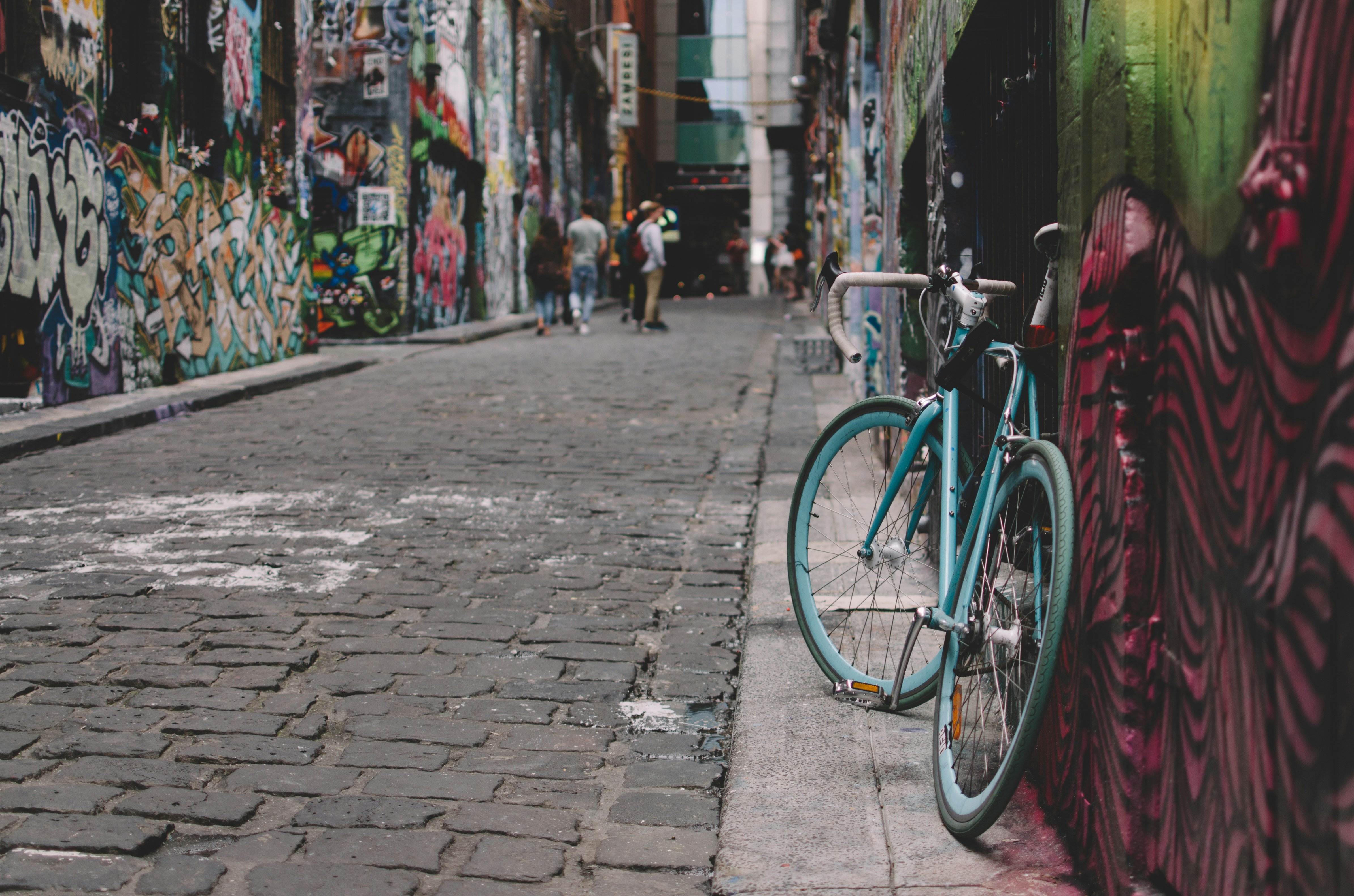 black and blue full-suspension bike parked beside wall