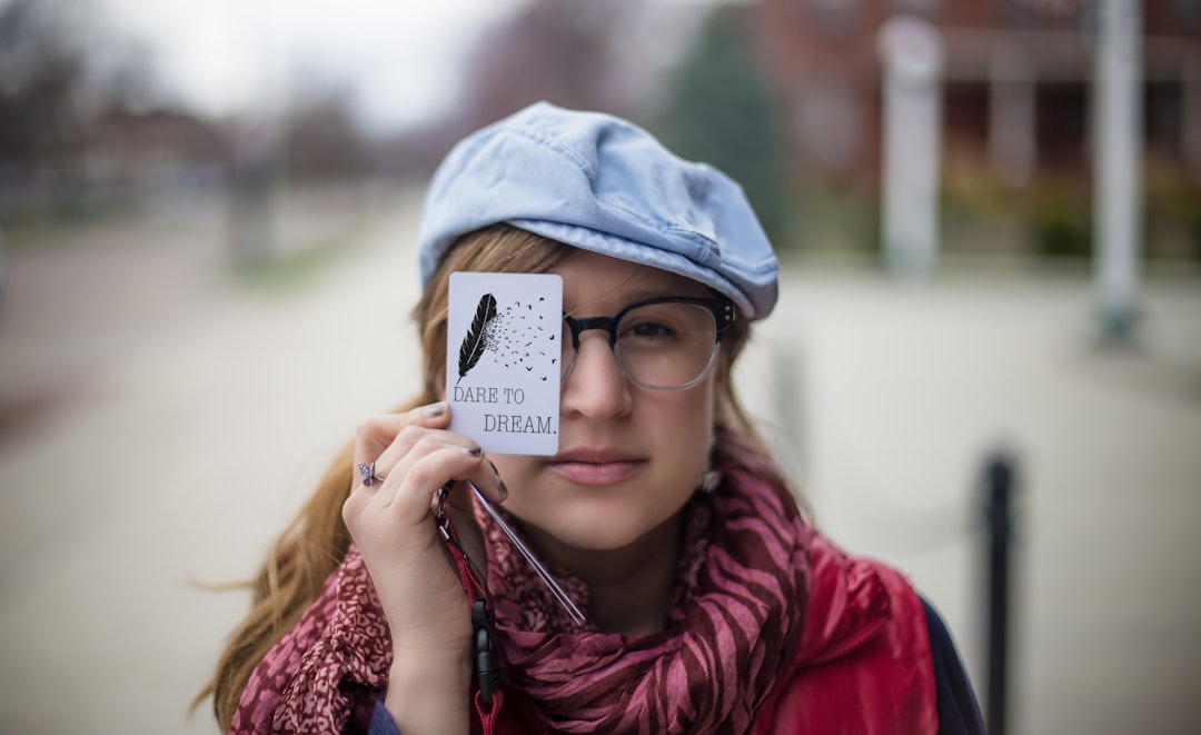 woman holding white card,