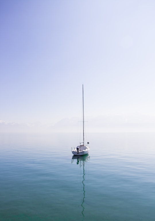 white boat on a body of water in Lausanne Switzerland