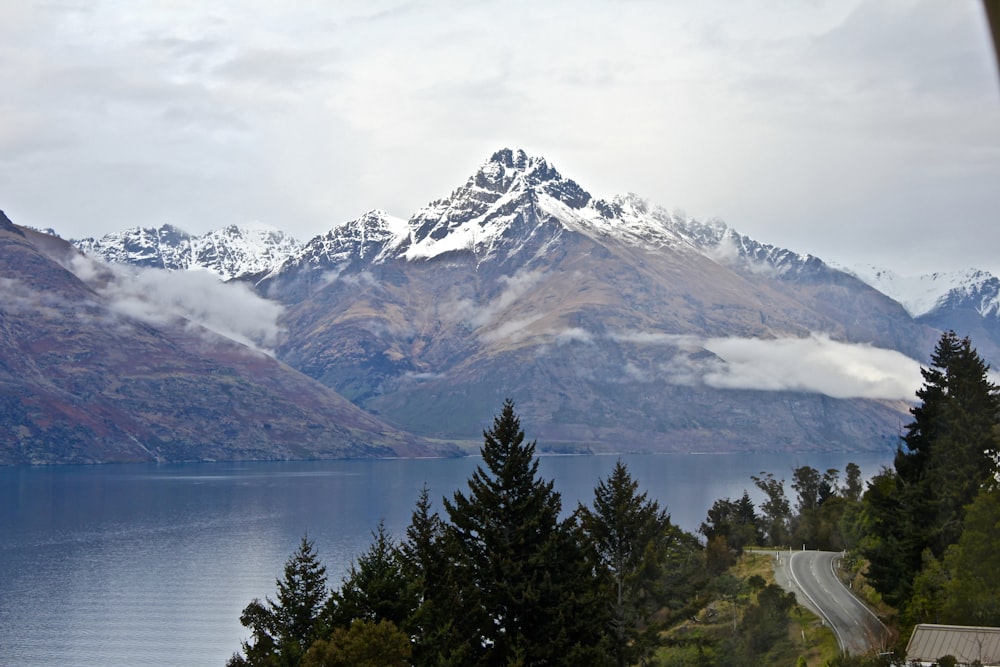 body of water near mountain at daytime