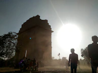 A panoramic view of the monument site at golden hour, with soft light casting long shadows.