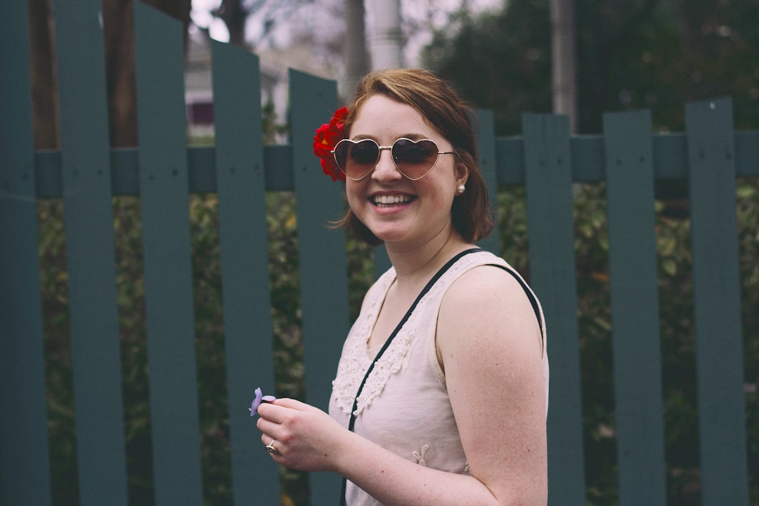 Joyful woman in heart sunglasses