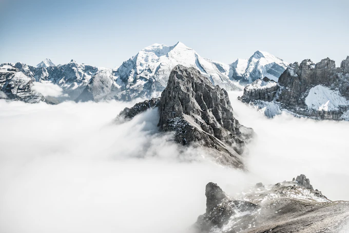Snowy mountain peaks above low clouds.