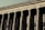 A grand neoclassical building with large stone columns supports a façade inscribed with the words 'FACULTAD DE DERECHO Y CIENCIAS.' The architectural style reflects an imposing and formal design, characteristic of institutional or governmental structures.