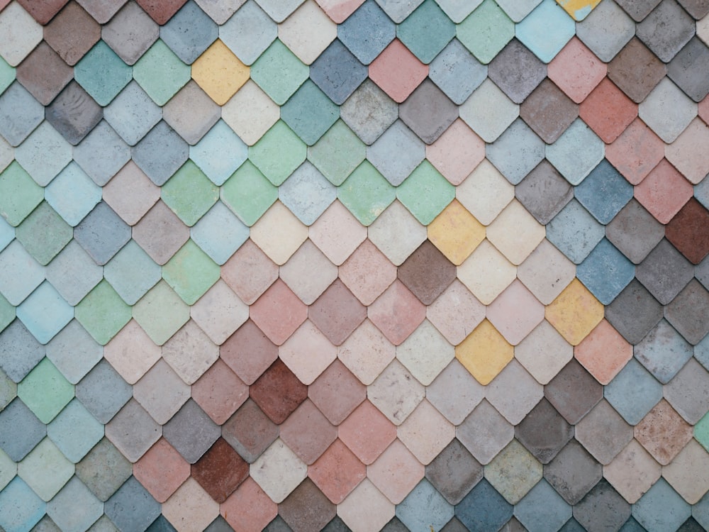 a multicolored tile wall with a pattern of small squares