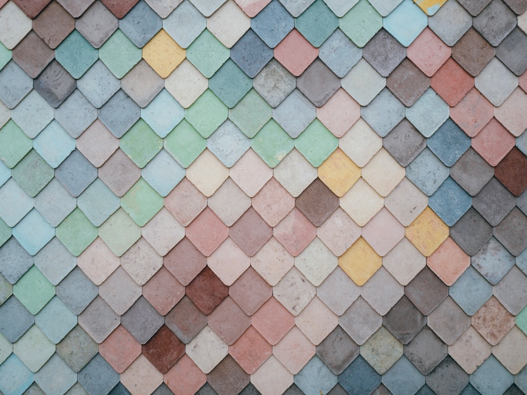 a multicolored tile wall with a pattern of small squares,