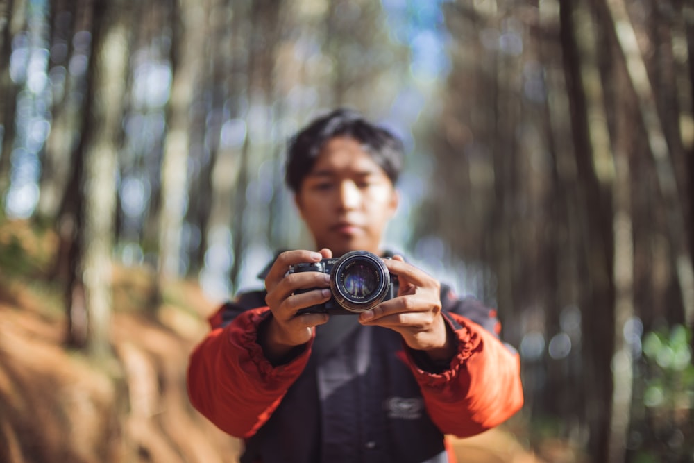 man holding camera taking a photo