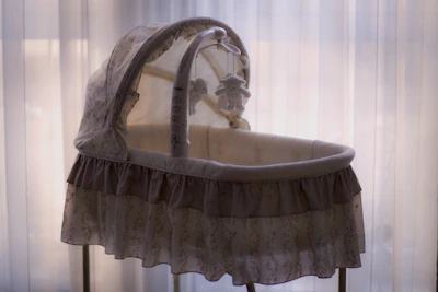 An elegant newborn canopy with subtle illumination, highlighting its unique design details.