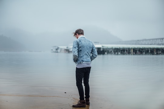 man in blue denim jacket standing on shore in Redding United States