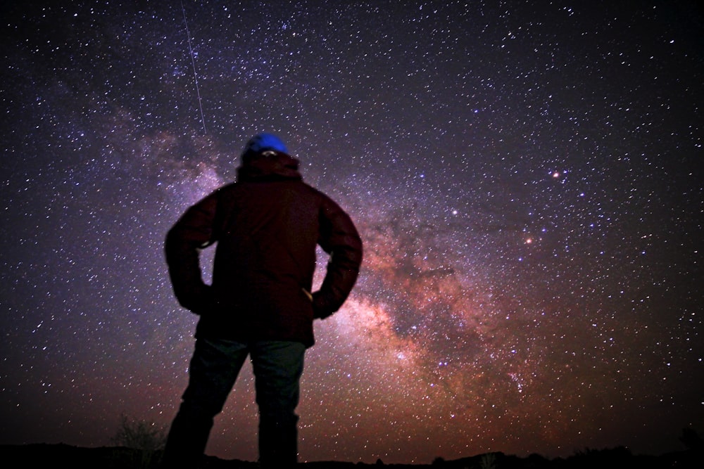 A man standing on top of a car under a night sky photo – Free Stars Image  on Unsplash