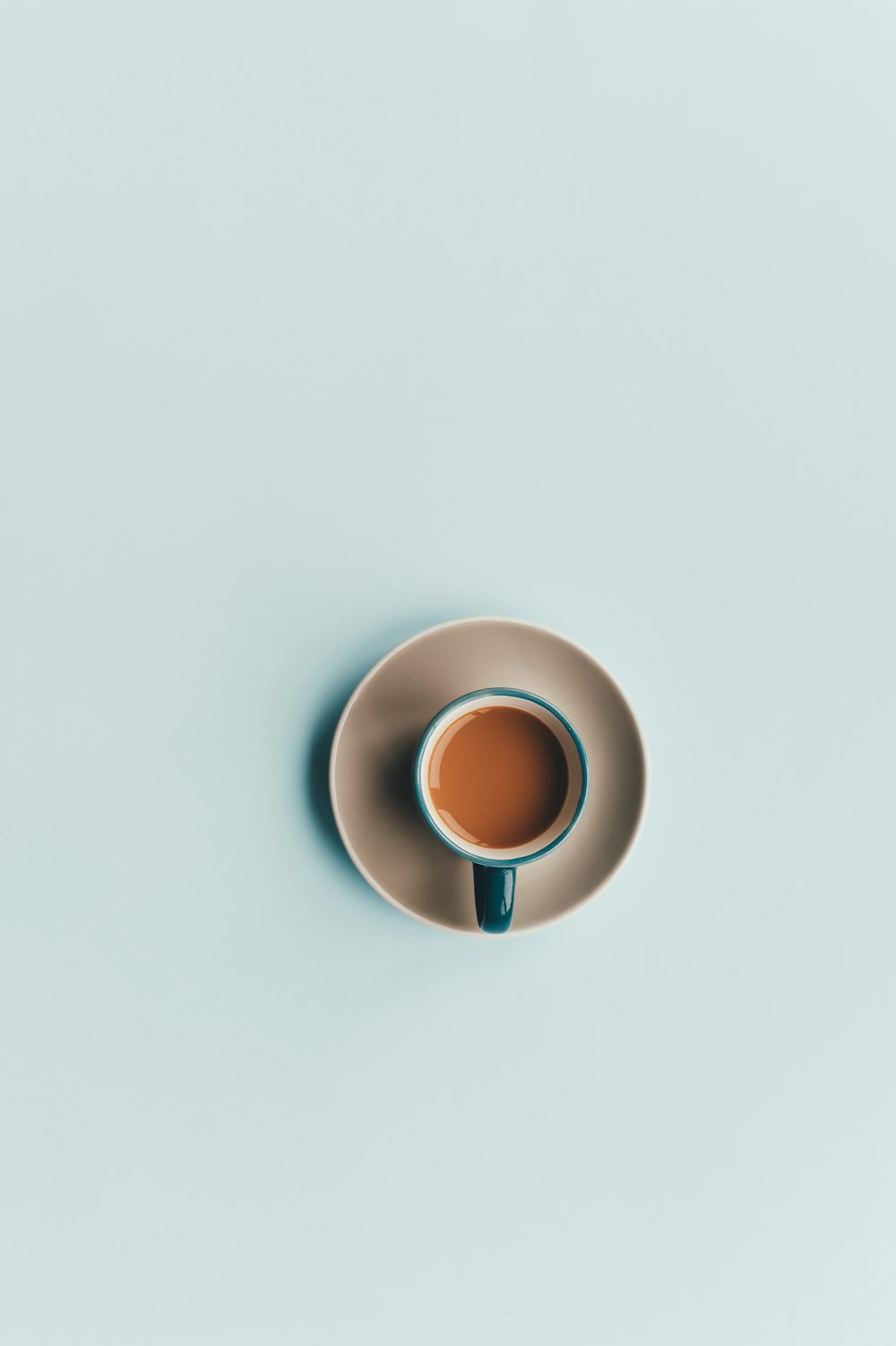 blue ceramic coffee cup and white saucer