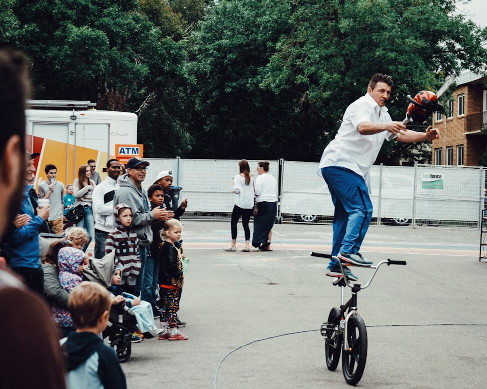 man standing on BMX bike