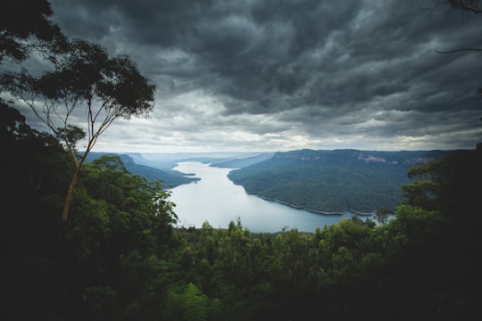 lake surround by mountains under nimbus clouds in Blue Mountains Australia