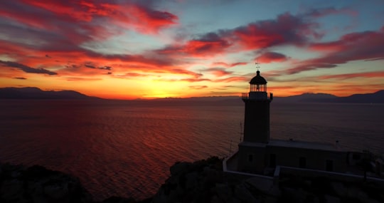 photo of lighthouse and a sunset in Loutraki Greece