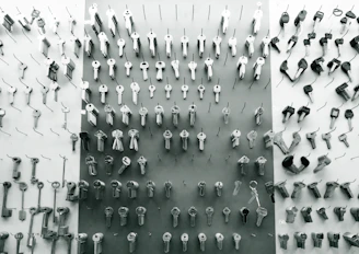A set of various keys and locks neatly arranged on a workshop table.