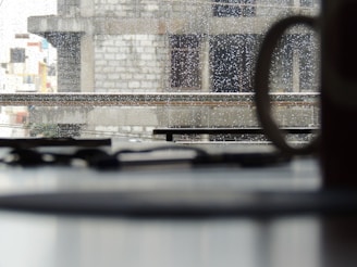 Close-up of a sleek window frame with raindrops on the glass, highlighting quality craftsmanship.