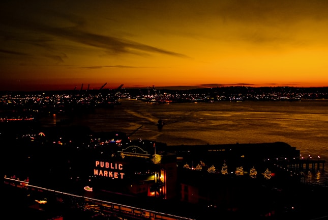 A bold vintage poster of Sarasota’s iconic bayfront at sunset, glowing with warm oranges and deep blues.