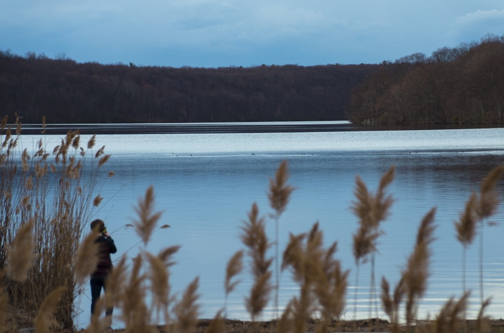 a person standing in front of a body of water