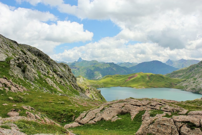 A tranquil mountain landscape showcasing lush greenery and serene skies.
