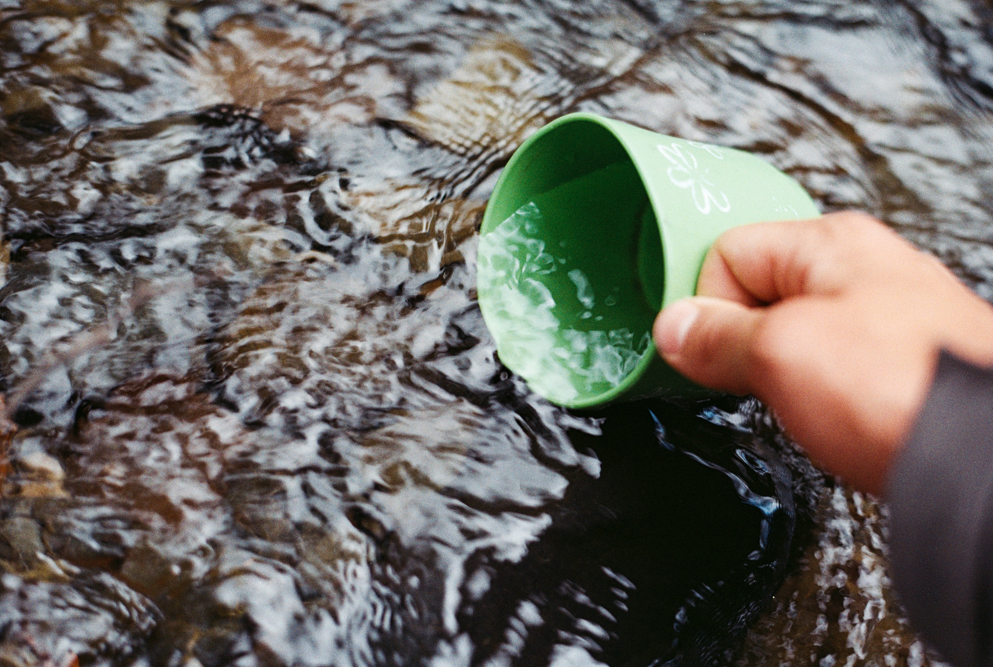 focus photo of person scooping water