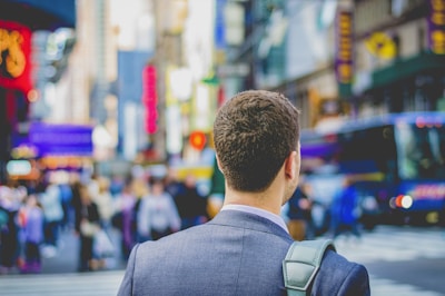 shallow focus photography of man in suit jacket's back