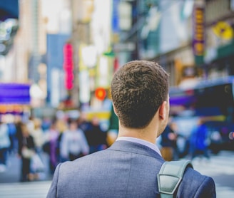 shallow focus photography of man in suit jacket's back