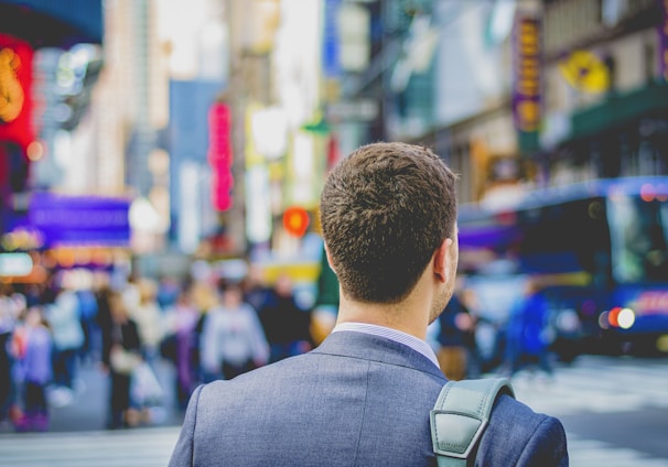 shallow focus photography of man in suit jacket's back