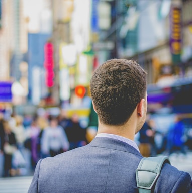 shallow focus photography of man in suit jacket's back