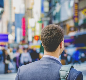 shallow focus photography of man in suit jacket's back