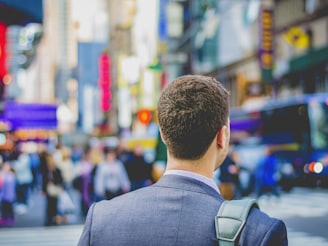 shallow focus photography of man in suit jacket's back