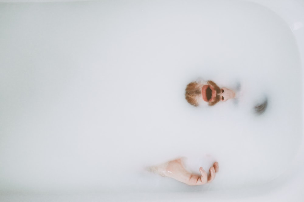 person on bath tub showing beard