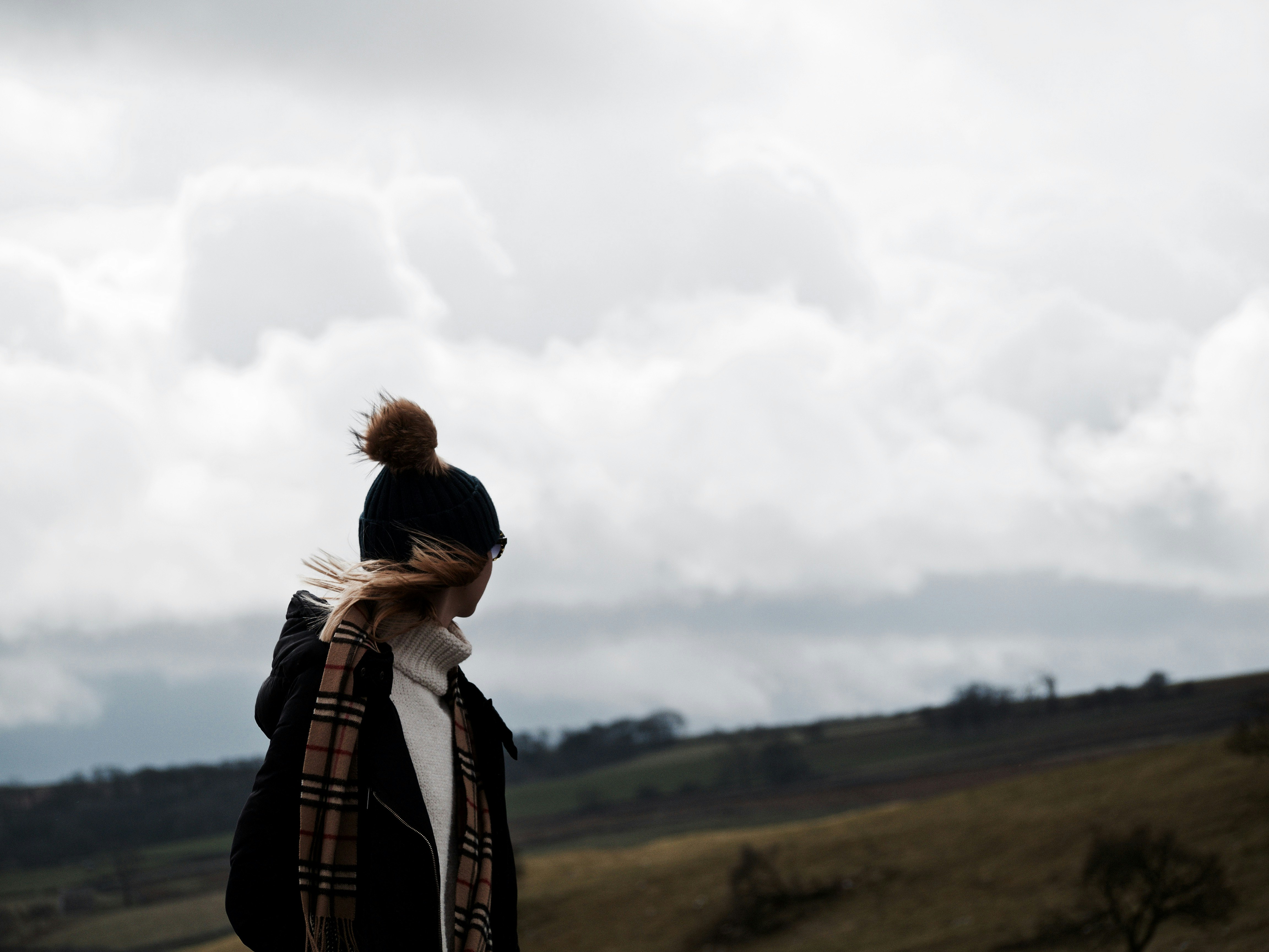 woman looking at back under nimbus clouds