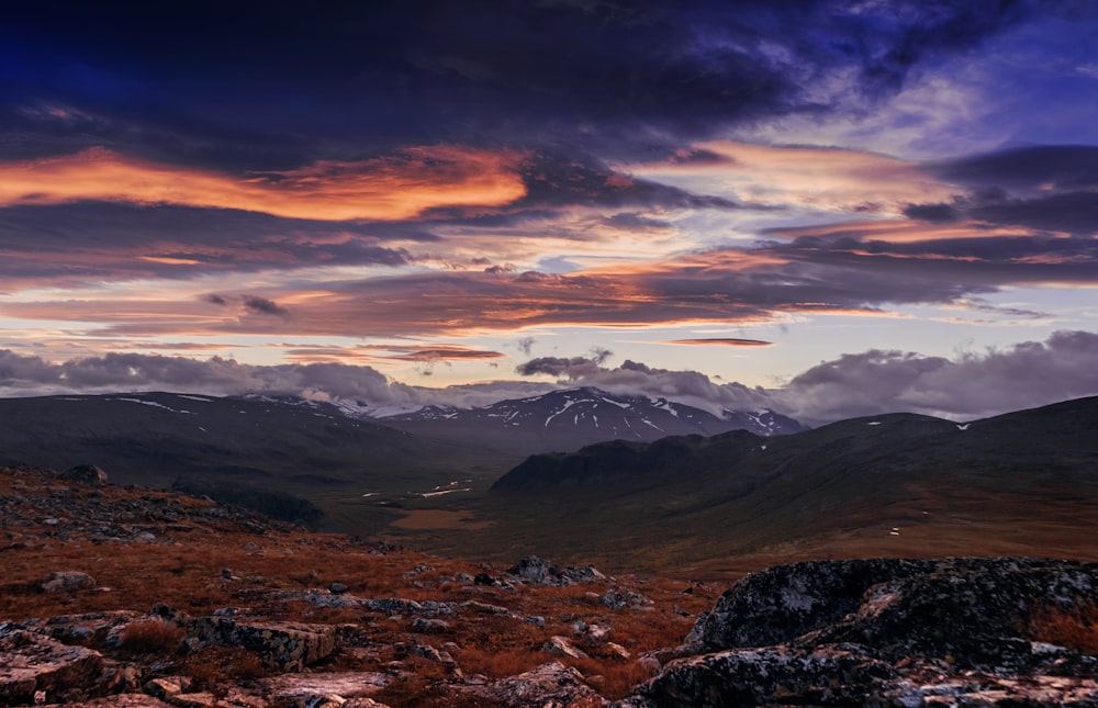 aerial view of mountains under dark cloudy sky