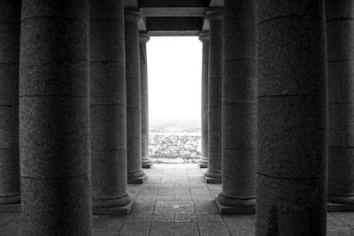 Exterior shot of a sturdy, classical Roman column blending modern cityscape with timeless strength.