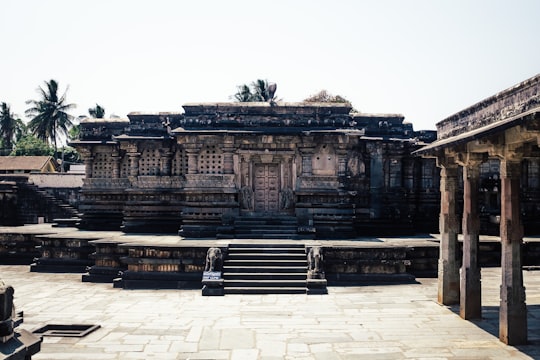 brown concrete building under white sky during daytime in Belur Chennakeshava Temple India