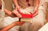 Close-up of hands exchanging a legacy book representing family heritage