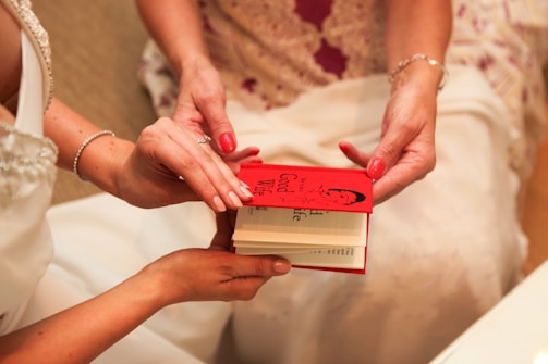 Close-up of hands exchanging a legacy book representing family heritage
