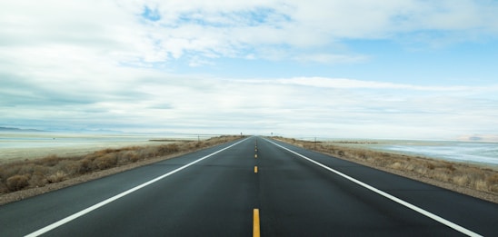 A long, empty road stretching towards the horizon, symbolizing the search for authenticity.